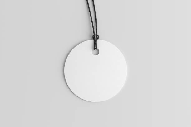 istock White round tag mockup on white background. View directly above 1491560983