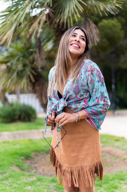 istock Happy woman looking up while holding sunglasses on a garden 1491561735