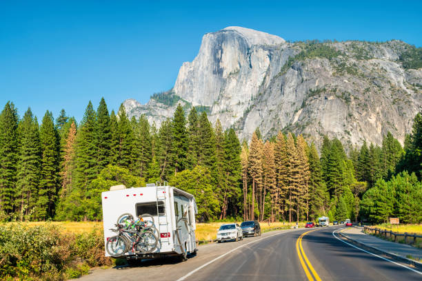 RV Yosemite National Park California USA RV with bicycles in Yosemite National Park, California, USA with the landmark Half Dome in the background. mariposa county stock pictures, royalty-free photos & images