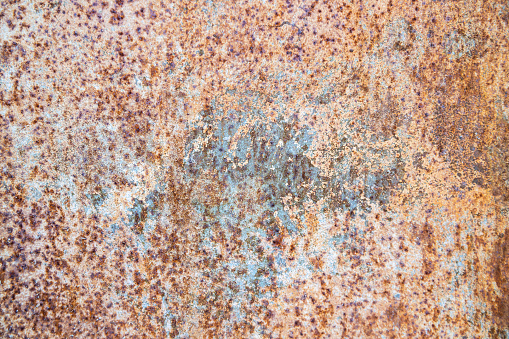 Rust makes an interesting pattern on a light painted metal surface