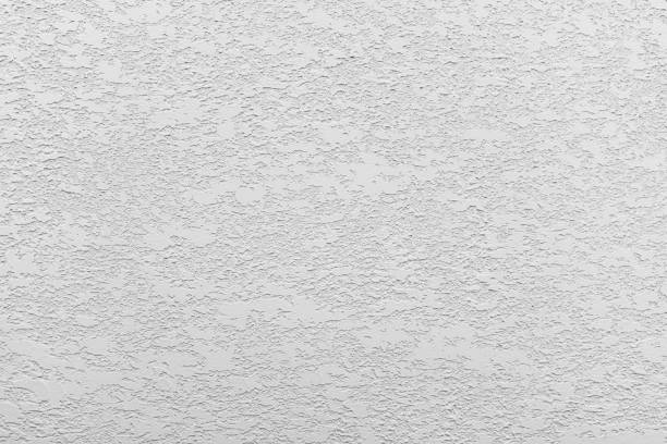 istock White-gray uniform background of decorative 2 layer plaster on the wall 1491564821