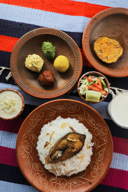 istock Khuder Bhat, Hilsa Khichuri Combo with salad, eggplant, borhani and Chui Pitha served in dish isolated on mat top view of indian and bangladeshi food 1491567082