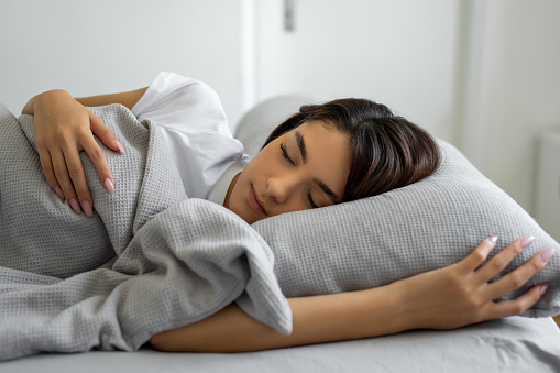 Woman sleeping peacefully in her bedroom