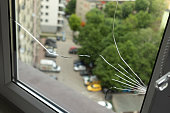 Crack, Broken Glass In A Double-glazed Window Due To Manufacturing Defect In Building, Home. Guarantee Manufacturer's Defective Products. Warranty. Horizontal Plane. Closeup