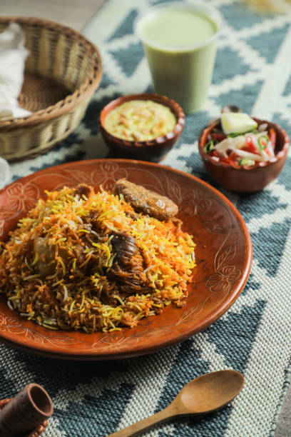 istock Mutton Kacchi biryani with salad, borhani and Chui Pitha served in dish isolated on mat top view of indian and bangladeshi food 1491568547