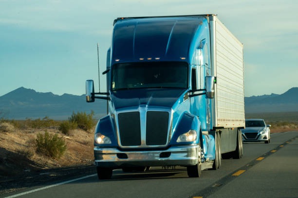 istock At sunset, a massive semi truck rumbled through the Nevada desert, its powerful engine echoing across the vast landscape. The majestic mountains stood tall in the background, witnessing the truck's journey through the rugged terrain. 1491568558