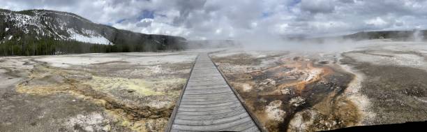 Old Faithful area in Yellowstone Old Faithful boardwalk pano near rainbow pool Yellowstone National Park mud volcano yellowstone stock pictures, royalty-free photos & images