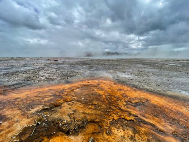 Old Faithful area in Yellowstone Old Faithful boardwalk pano near rainbow pool Yellowstone National Park mud volcano yellowstone stock pictures, royalty-free photos & images