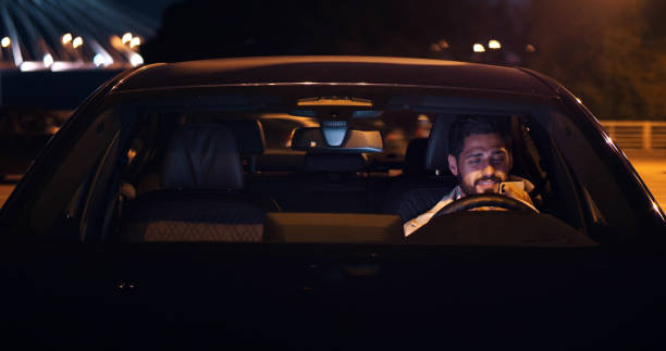 istock Man using mobile phone sitting in car outdoors at night 1491572629