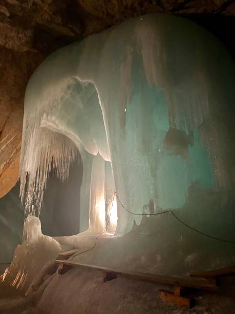 Ice cave. Ice in the cave. Illuminated cave.
