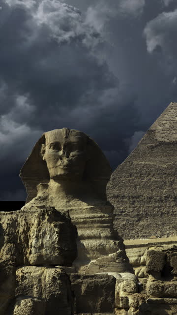Pyramid and sphinx and storm clouds