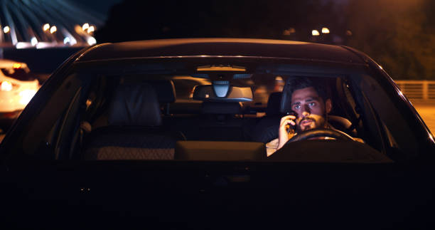 istock Angry man sitting in car and arguing on smartphone late in evening 1491573902