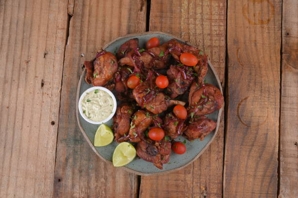 istock fried chicken with tomatoes and caramelized onions wings with herb sauce 1491574495