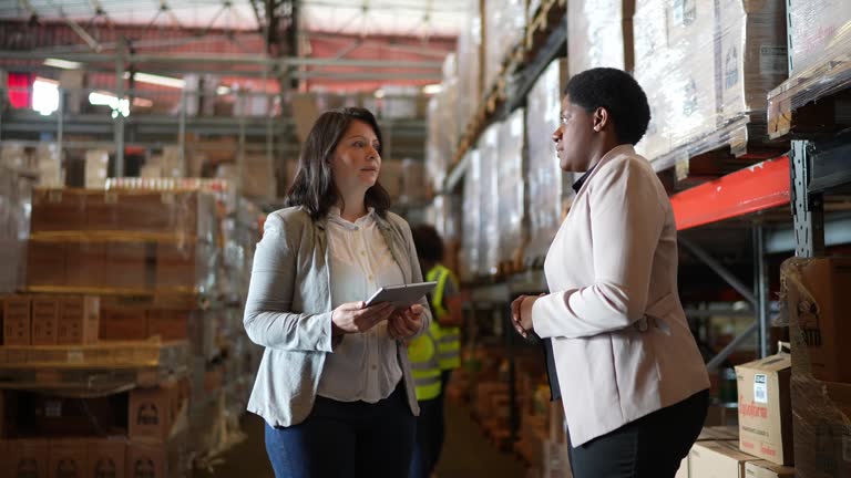 Coworkers talking in a warehouse