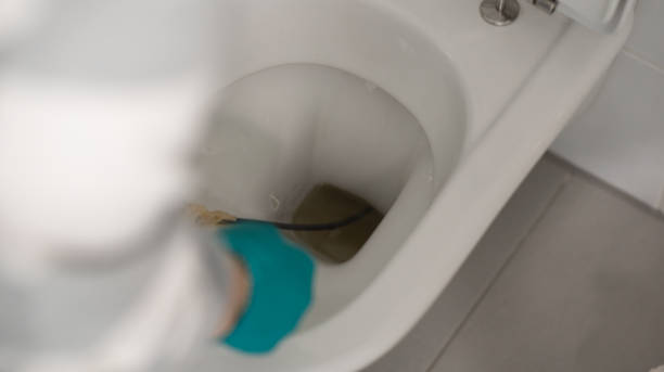 istock Man cleaning overflowing broken toilet. clogged toilet. 1491578621