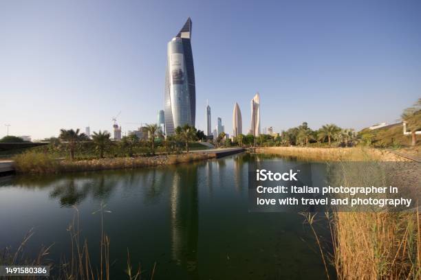 Modern Skyscraper Reflecting Into The Lake Water In Kuwait City Stock Photo - Download Image Now