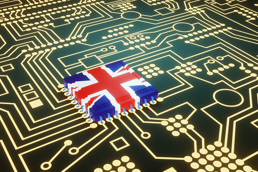 An advanced CPU printed with a flag of UK on a neon glowing electronic circuit board. Illustration of the concept of United Kingdom made high-end micro chips.
