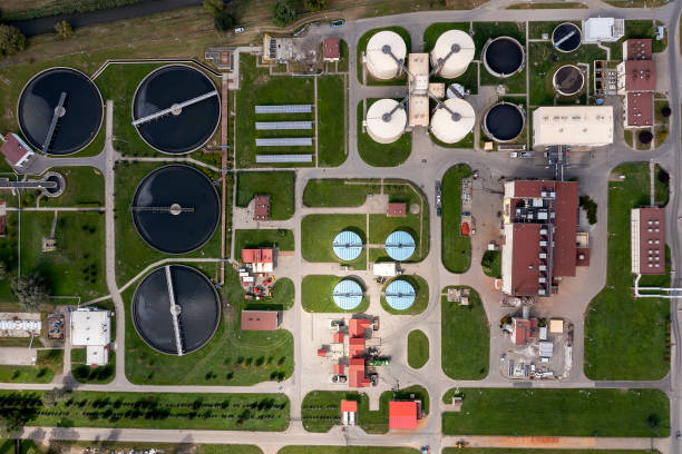 Sewage treatment plant, aerial view Sewage treatment plant in an industrial district viewed from directly above. public utility stock pictures, royalty-free photos & images