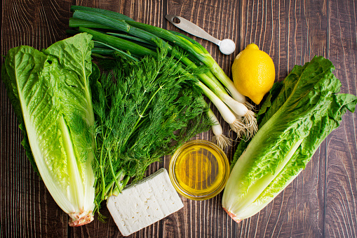 Hearts of romaine, feta cheese, olive oil, and other salad ingredients