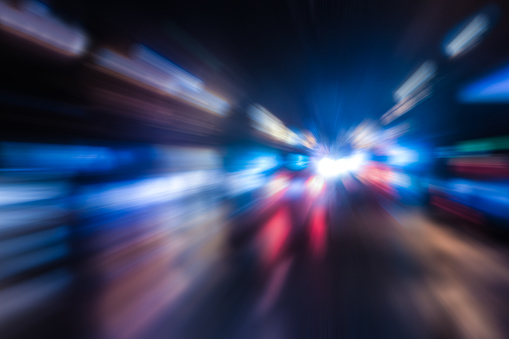Car traffic in the night city. Blurred motion, defocus