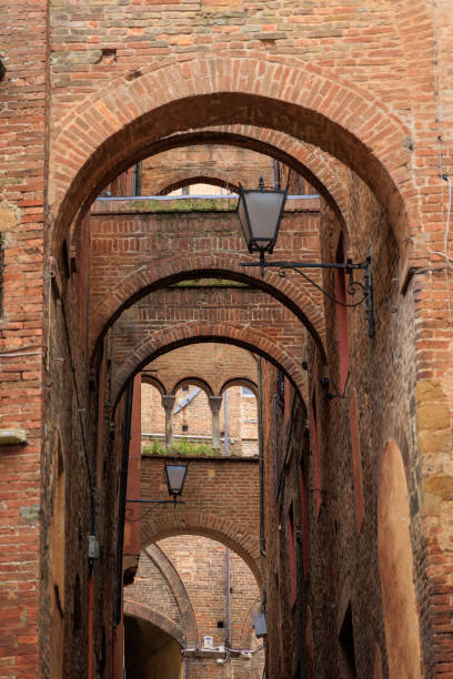 istock Street in Siena, buttress arch 1491600833