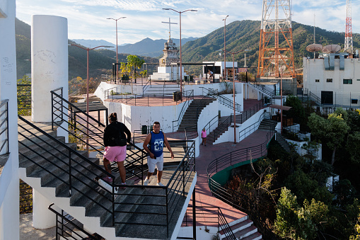 Mirador el Cerro de la Cruz (Hill of the Cross Viewpoint). In this photo you see the top of the stairway that leads to viewpoint. People are visible on the stairs both in the forground and background.