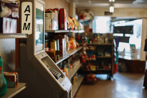 ATM machine inside the convenience store ATM machine inside a small local business American convenience store (bodega). liquor store counter photos stock pictures, royalty-free photos & images