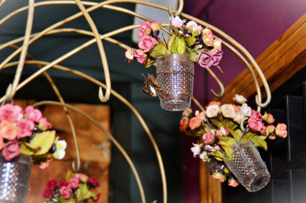 istock Several glass cups with hanging artificial flowers decorating the environment 1491605242