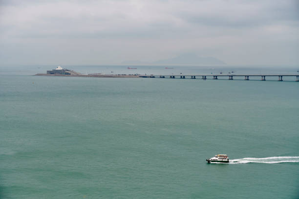 A tourist ferry sailing nearby the Hong KongZhuhaiMacau Bridge. South China Sea. Hong Kong.