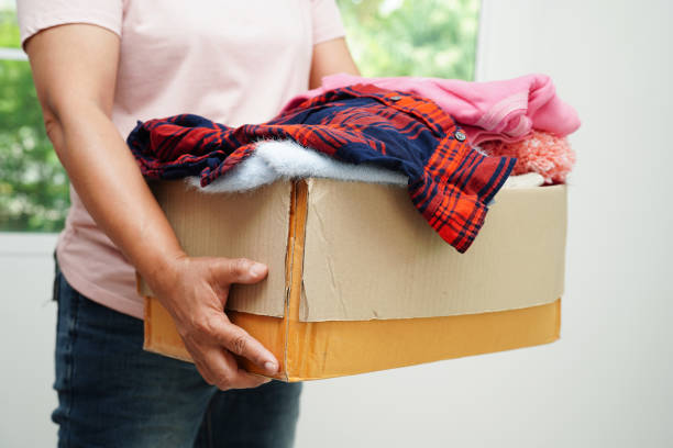 istock Clothes donations in cardboard box for volunteer. 1491612205