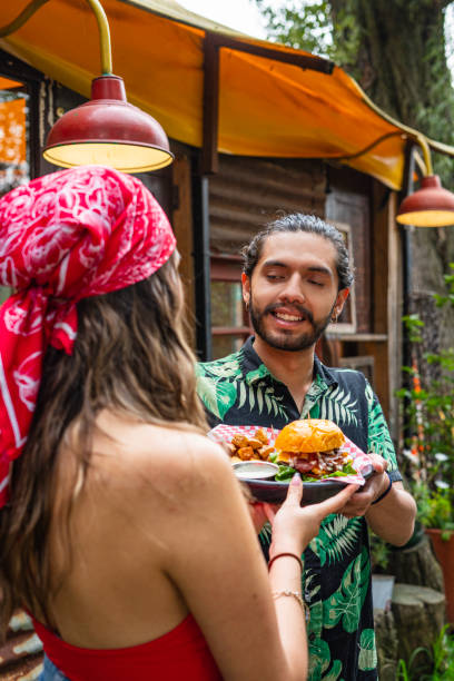 istock Waiter is bringing her food to a customer 1491612290