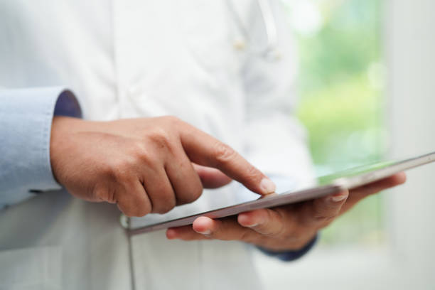 istock Asian man doctor using tablet computer to reading patient report, check up and search for solve treatment health medical online in hospital. 1491612304