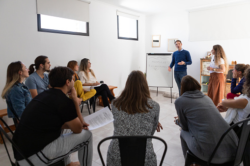 Mindfulness and yoga teachers explaining breathing techniques in a group class - Buenos Aires - Argentina