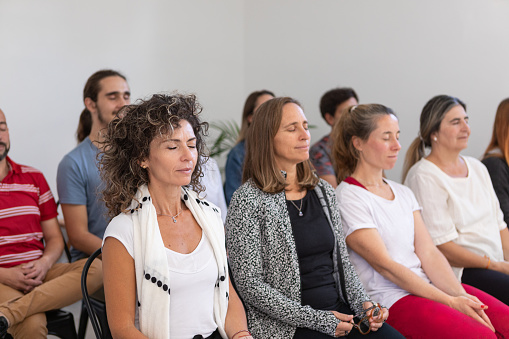 Mindfulness and yoga teachers explaining breathing techniques in a group class - Buenos Aires - Argentina