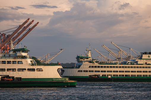 Seattle, USA - May 15, 2023: Elliott Bay late in the day as a Ferris approach and depart the new Colman dock late in the day.
