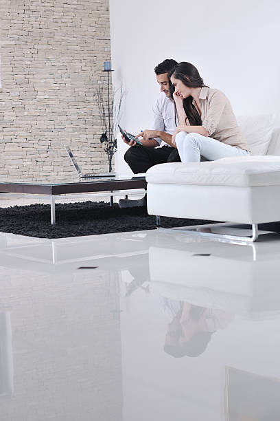 istock couple relax and work on laptop computer at modern home 149161493