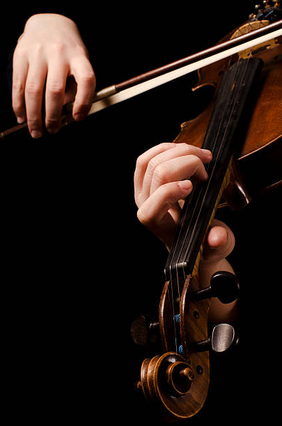 istock Female hands play a violin on the black 149161643