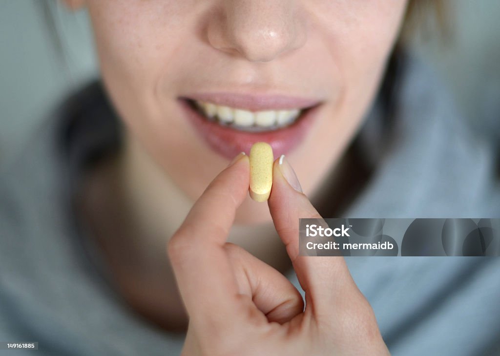 Person about to take medication Take your medication Birth Control Pill Stock Photo