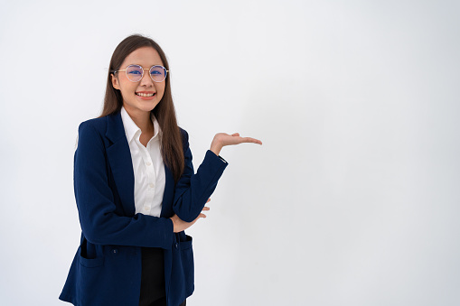 Portrait of smart and happy young thoughtful Asian business women open palm hand on isolated white background. Concept of advertising marketing and product placement.