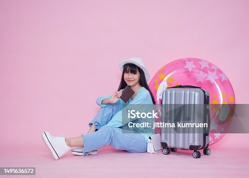 istock Woman with suitcase and passport for summer trip 1491636572