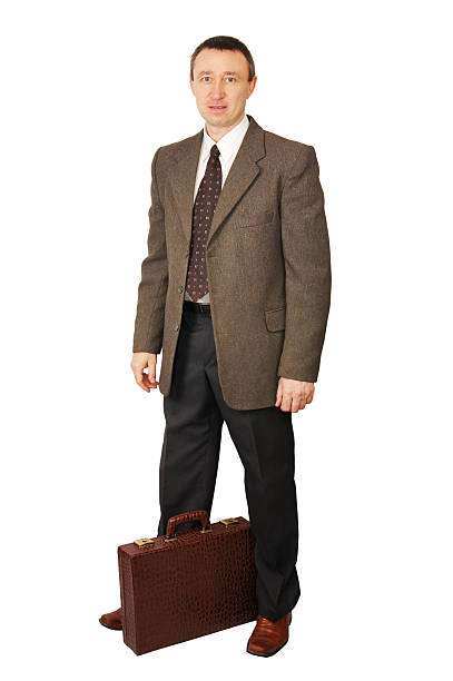 istock Man dressed in dark trousers and green coat with suitcase 149163814