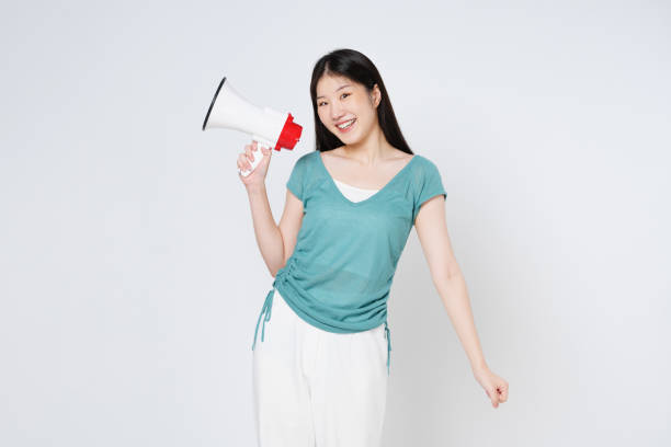 istock Young woman holding megaphone isolated on white background. 1491638245