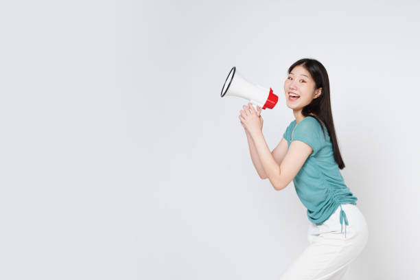istock Young woman holding megaphone isolated on white background. 1491638251