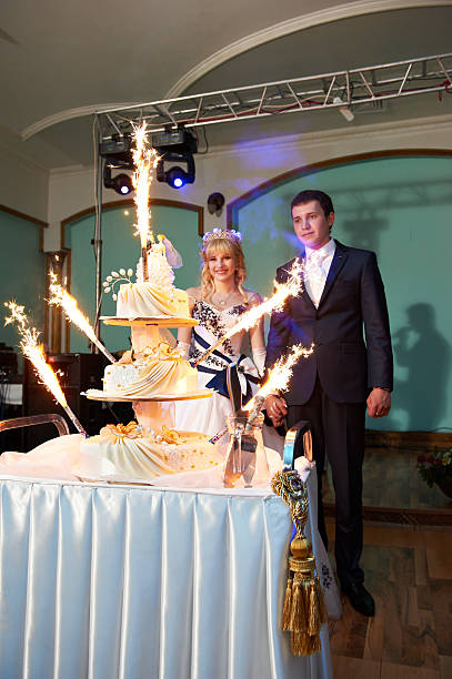 istock Wedding cake with sparklers and newlyweds 149163882
