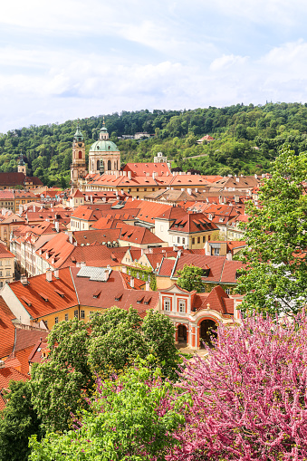View on the Saint Nicolas Cathedral and the red roofs of Lesser Town in Prague, Czech Republic