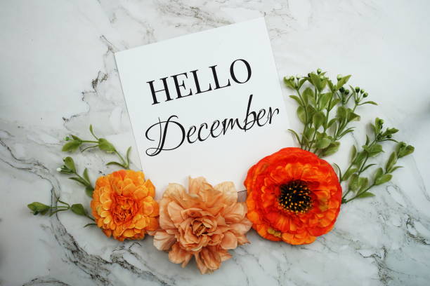 istock Hello December text with orange flower bouquet on marble background 1491640313
