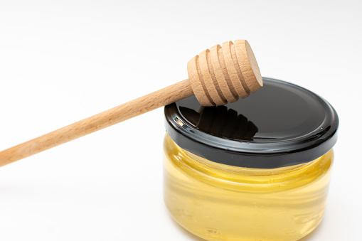 A jar of honey and a spindle spoon