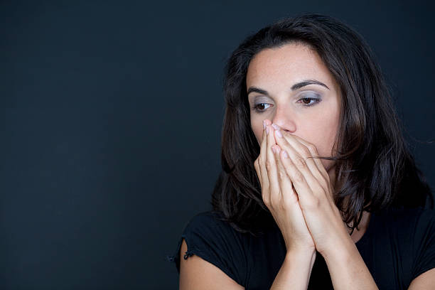 istock Woman desperate on black background 149164442