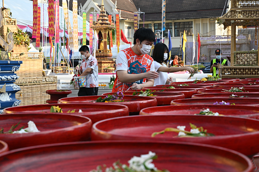 Chiangmai, Thailand - May 20, 2023: the flower trays for worship flowers.\n\nCeremony of wearing flower bowls to worship Inthakhin pillars (Chiang Mai City Pillar) for the year 2023, a merit-making event that has been inherited for a long time. Chiang Mai people will worship Inthakhin at the end of the 8th month, the 9th month, or between May and June.\n\nThis year, held on May 16-22, 2023 and May 23, 2023, is a merit-making day at Wat Chedi Luang Worawihan. Mueang Chiang Mai District Chiang Mai Province