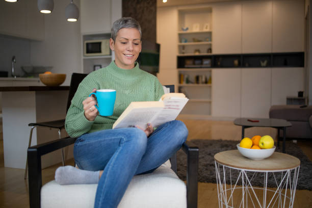 istock Woman relaxing and reading a book 1491646666
